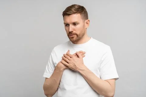 Man has breathing problems, panic attack, suffocation holding hands on chest on Stock Photos