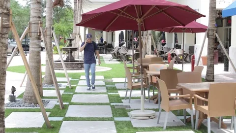 Man has Conversation on Phone with Client Outside Stock Footage 76484032