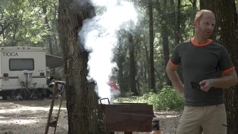 Man has Conversation While Cooking with Class C Motorhome Stock Footage