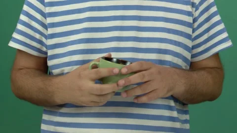 The man has a green cup in his hand Video stock 344588738