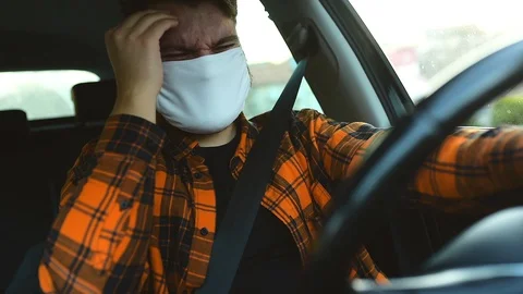 A man has a headache in the car Stock Footage 128248831