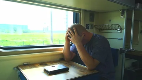 Man has a headache on the train Stock Footage 155723605
