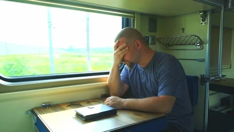 Man has a headache on the train Stock Footage 156172053