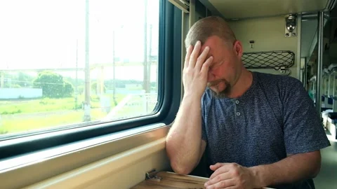 Man has a headache on the train Stock Footage 156814528