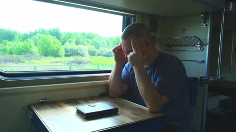 Man has a headache on the train Stock Footage 157084972