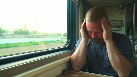 Man has a headache on the train Stock Footage 157114978
