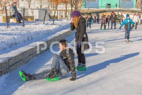 A man has hurt himself while ice skating Stock Photos
