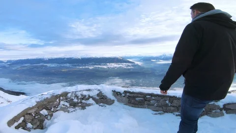 Man has made it to a top of mountain and celebrates the achivement with cheer Stock Footage 100052822