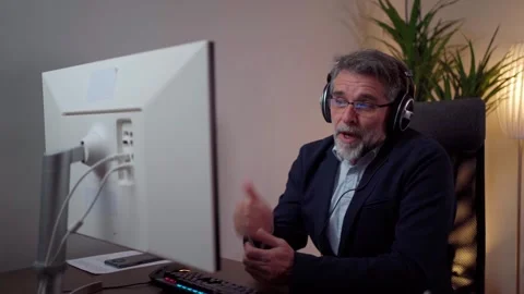 A man has a pleasant conversation via webcam with colleagues at work Stock Footage 268328144