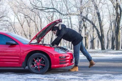 Man has problems with the car on winter road. Stock Photos