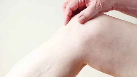 Man has sore knee with copy space Stock Footage