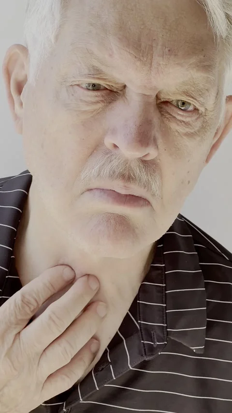 Man has throat or thyroid issues vertical Stock Footage 219283577