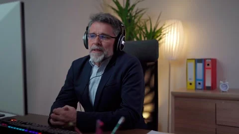 Man has a video call via webcam in the office while using headphones Stock-Footage 268328066