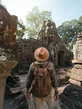 Man With Hat and Backpack Explores Ancient Ruins of Ta Som Temple Stock Photos