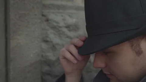 A man in a hat and coat Stock Footage 72635190