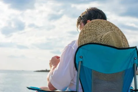 Man with hat on beach Stock Photos