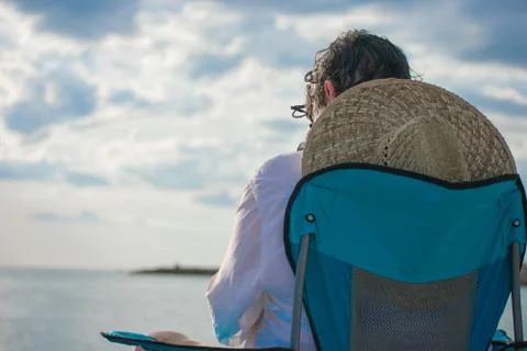 Man with hat on beach Stock Photos