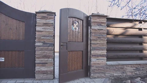 Man in a hat comes out of the yard Stock Footage 164123470