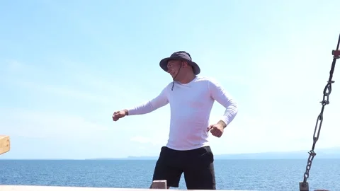 A man in a hat dancing against the sky. Stock Footage 294650767