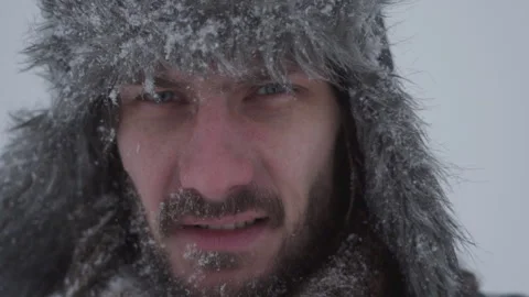 A man in a hat with earflaps in the snow Stock Footage 258270828