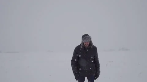 A man in a hat with earflaps in the snow Stock Footage 258569537