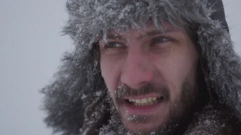 A man in a hat with earflaps in the snow Stock Footage 258569727