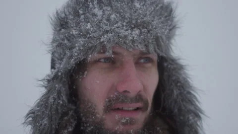 A man in a hat with earflaps in the snow Stock Footage 258733596