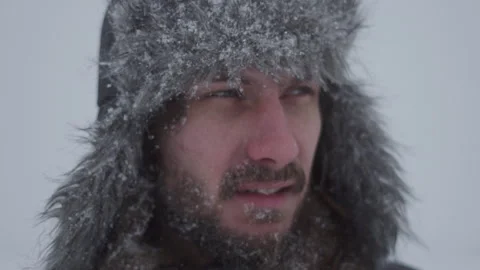 A man in a hat with earflaps in the snow Stock Footage 259293246