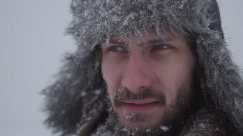A man in a hat with earflaps in the snow Stock Footage 260800831