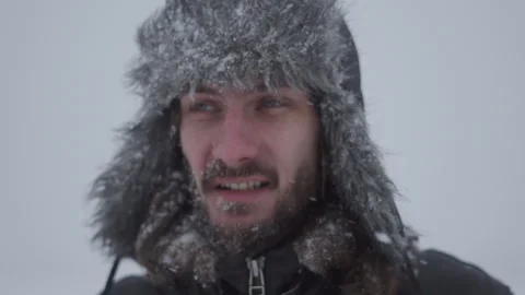 A man in a hat with earflaps in the snow Stock Footage 260800920
