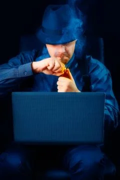 Man with Hat Lighting Pipe Looking at Laptop Stock Photos
