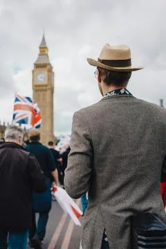 Man in Hat Overlooking Big Ben with Protest Crowd and Union Jack Flags Stock Photos