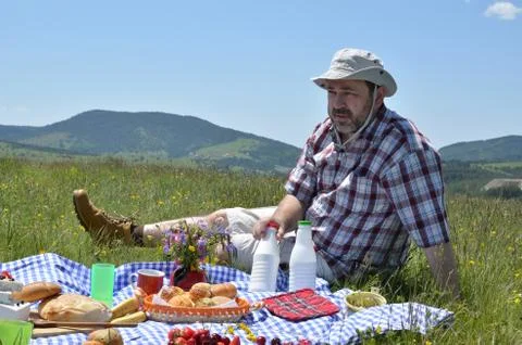 Man with Hat on Picnic Stock Photos