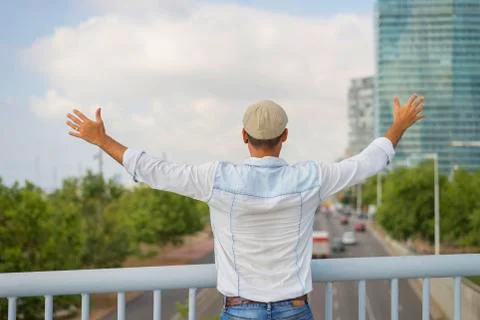 Man with hat standing and looking the skyline of the city. Stock Photos
