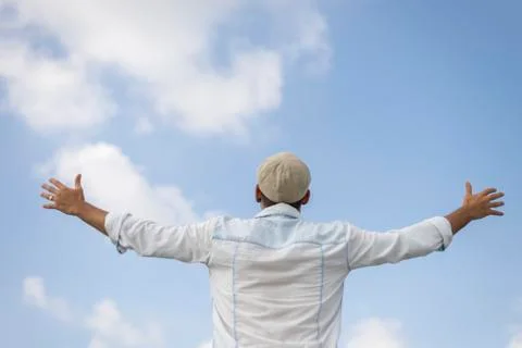 Man with hat standing and looking the skyline of the city. Stock Photos