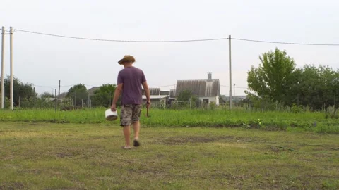 A man in a hat walks around the area 4K Stock Footage 325988078
