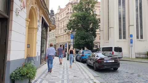 A man in a hat walks through the old center of Prague Stock Footage 157593755