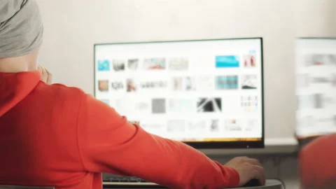 A man in a hat works on a computer Stock Footage 151019474