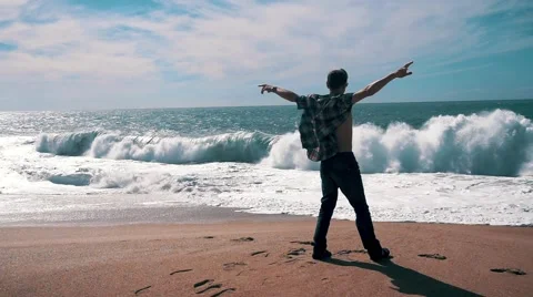 Man Have Fun on Beach with Big Waves Stock Footage 55789274