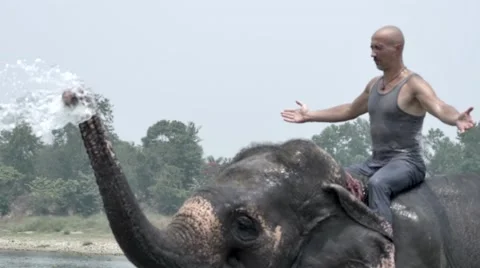 Man have a shower on the elephant Stock Footage 67355435
