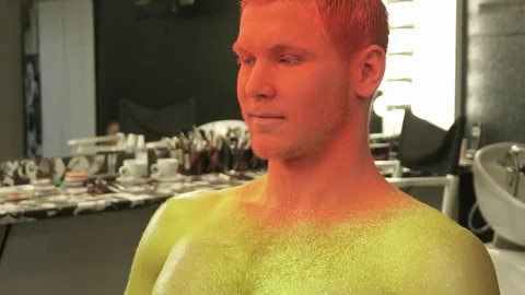 Man is having art makeup done in the studio, slow motion Stock Footage 73541858