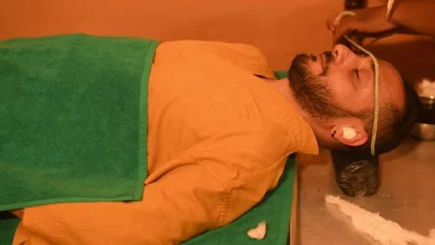 Man having Ayurveda healing therapy for head relaxation massage Video stock 174069464