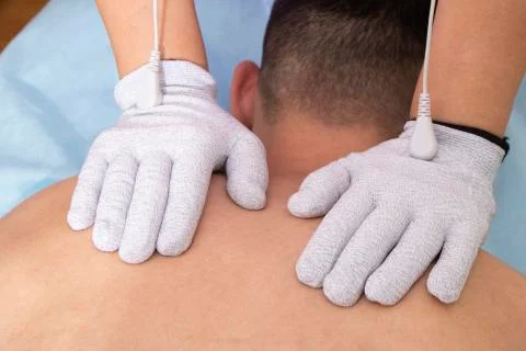 Man having back massage, physiotherapy with gloves Stock Photos