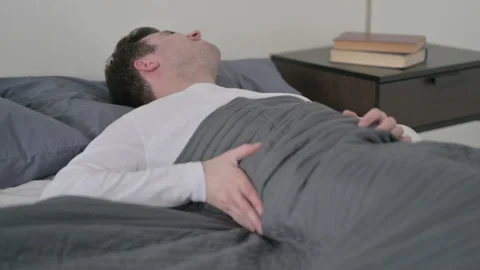 Man having Back Pain in Bed Stock Footage 169550708