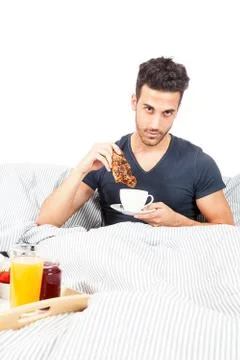 Man is having breakfast in the bed Foto stock