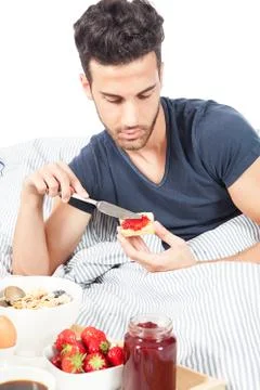 Man is having breakfast in the bed Foto stock
