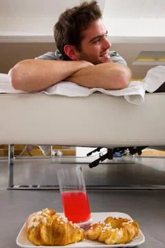 Man having breakfast in bed Stock Photos