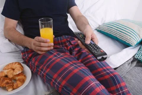 Man having breakfast in bed. Stock Photos