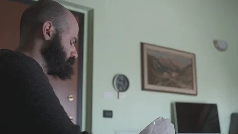 Man Having Breakfast Checks Time on Wall Clock Video stock 88911893