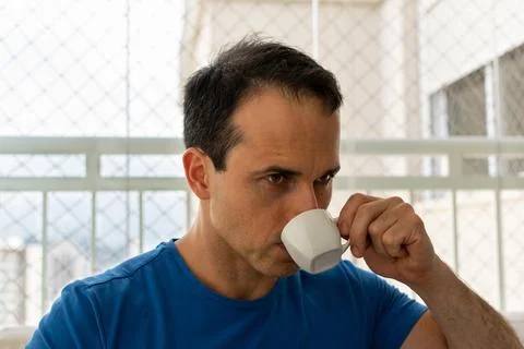 Man having coffee and looking at 45. Stock Photos